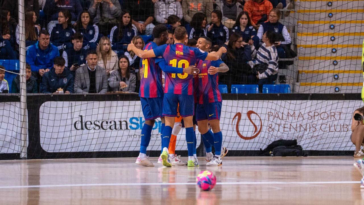FC Barcelona futsal players celebrating together on court